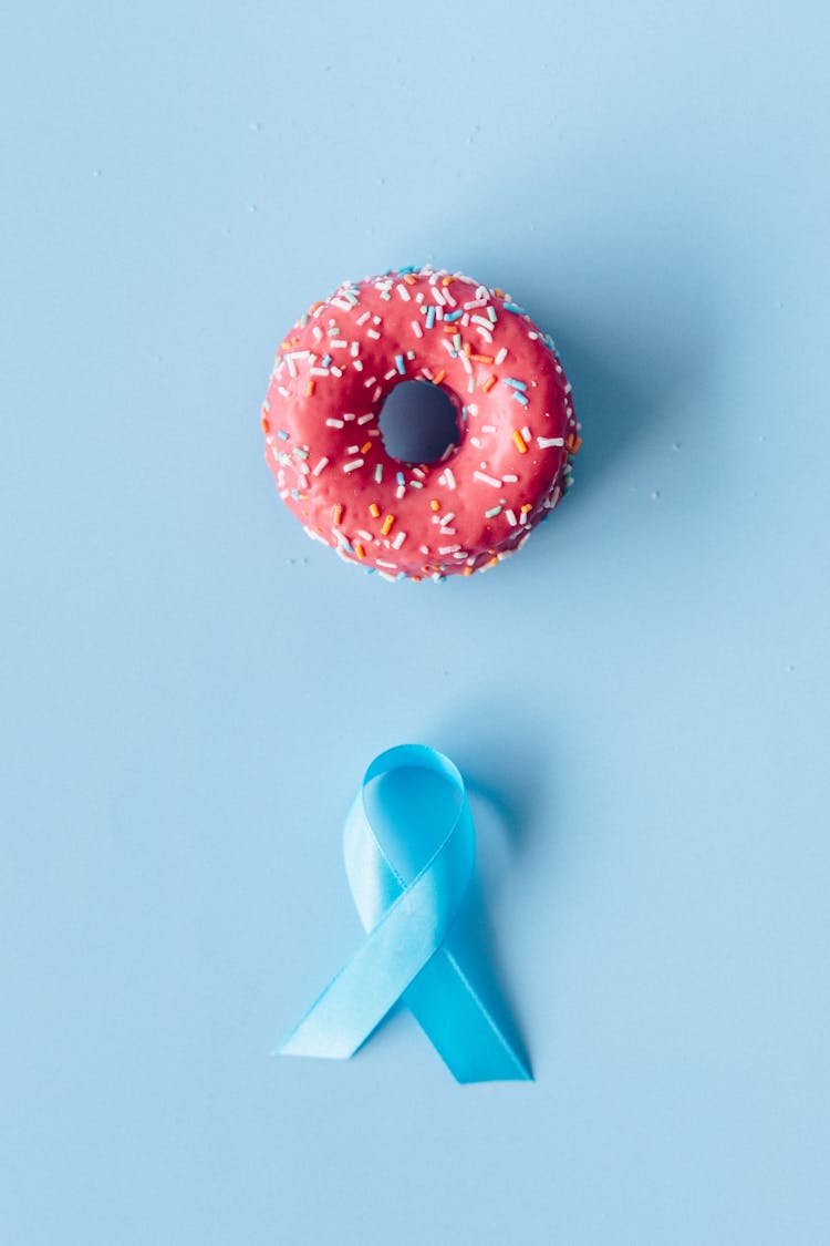 Donut And Ribbon On A Blue Background