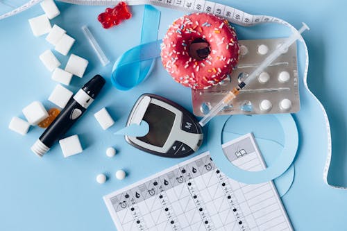 Free Blood Sugar Meter and Medication on the Blue Background Stock Photo