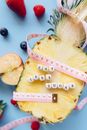 Tape Measure and Letter Blocks on a Sliced Pineapple