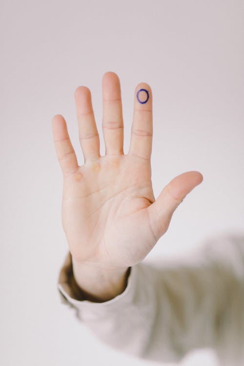 A Person with a Blue Mark on A Finger
