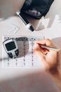 A Person Recording His Blood Sugar Reading