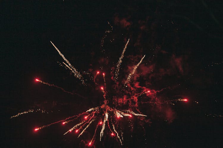 Glowing Fireworks Under Black Sky At Night