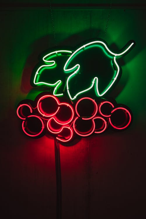 Glowing neon signboard with berries and leaves