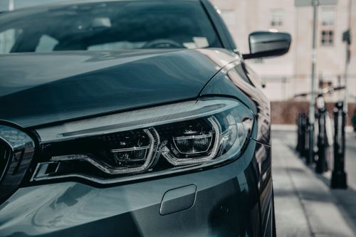 Free New shiny automobile on asphalt road near building in town street in daylight Stock Photo