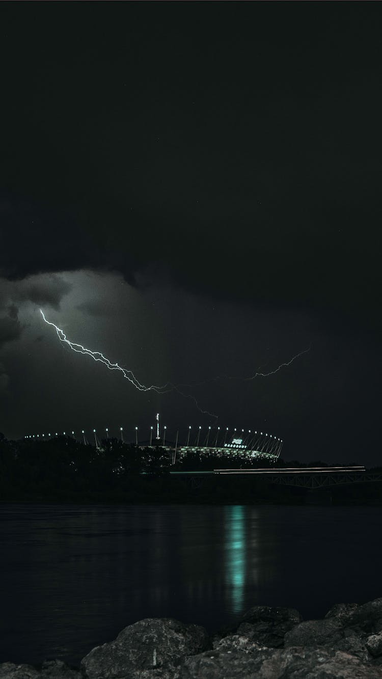 Stadium Near Sea At Night Time With Lightning