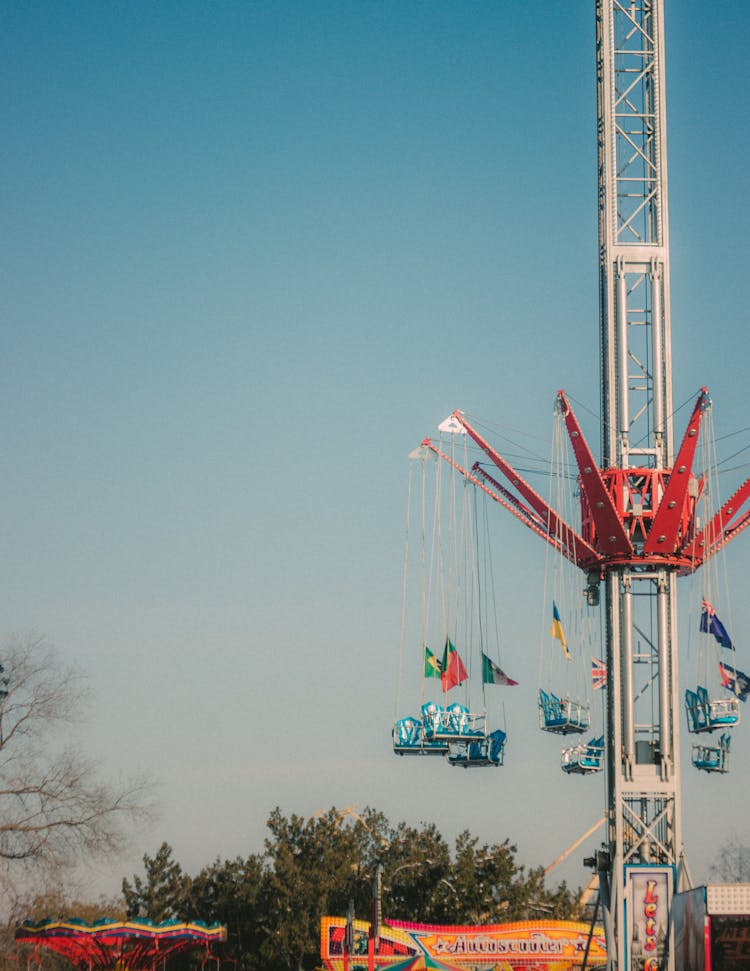 Tall Swing Ride In Amusement Park