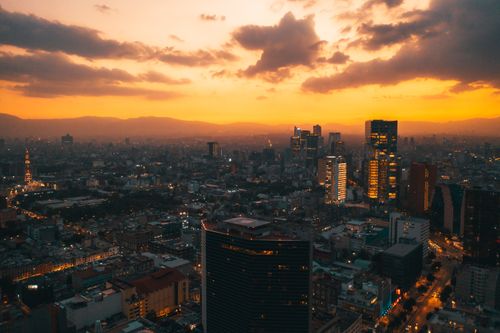 Free A breathtaking aerial view of a vibrant city skyline at sunset, showcasing skyscrapers and urban beauty. Stock Photo