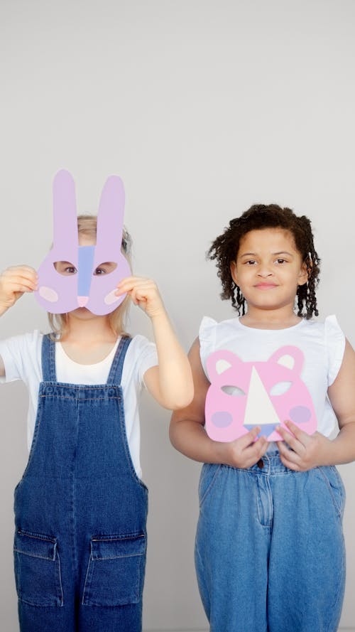 Free Two Girls Holding an Animal Paper Masks Stock Photo