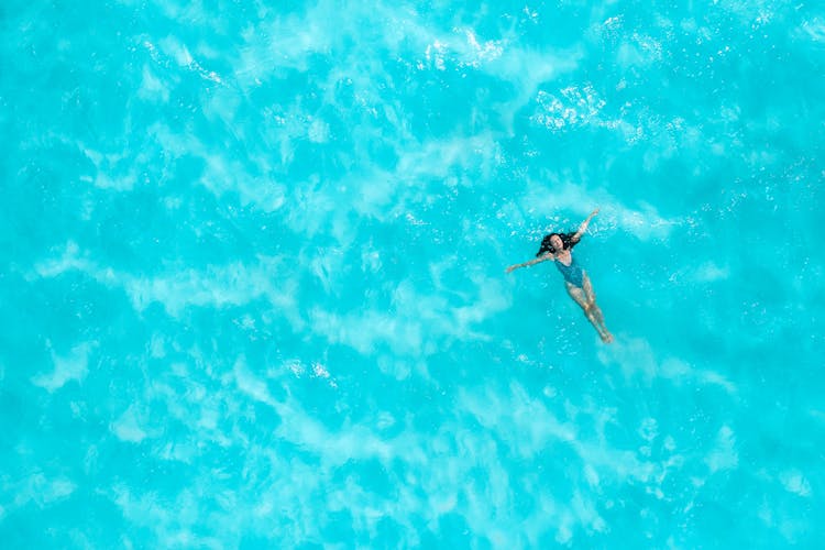 Aerial Photo Of A Woman Floating In The Ocean