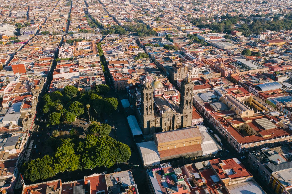 Stunning aerial shot capturing the Puebla Cathedral surrounded by vibrant cityscape in Mexico.