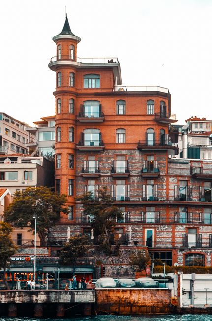 Exterior of brick historic Perili Kosk building located in Istanbul old district near river embankment in sunlight