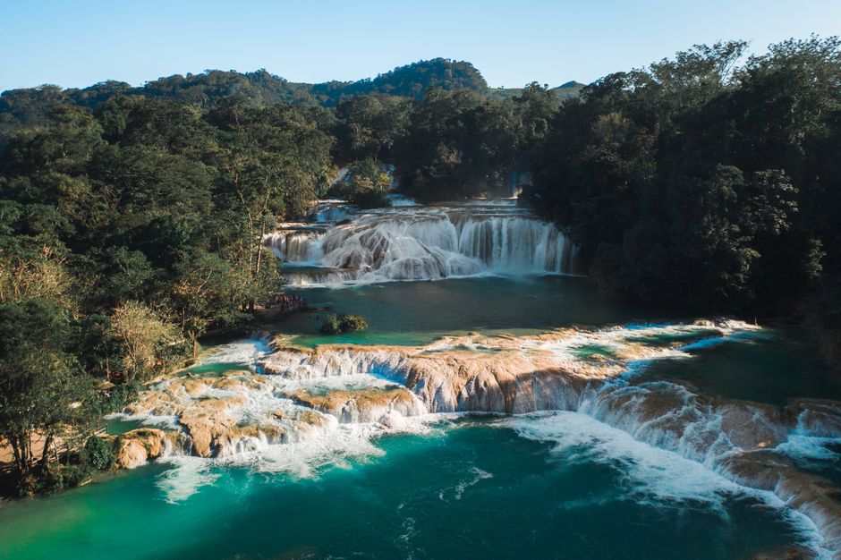 Stunning aerial shot of Agua Azul waterfalls surrounded by lush forest in Chiapas, Mexico.