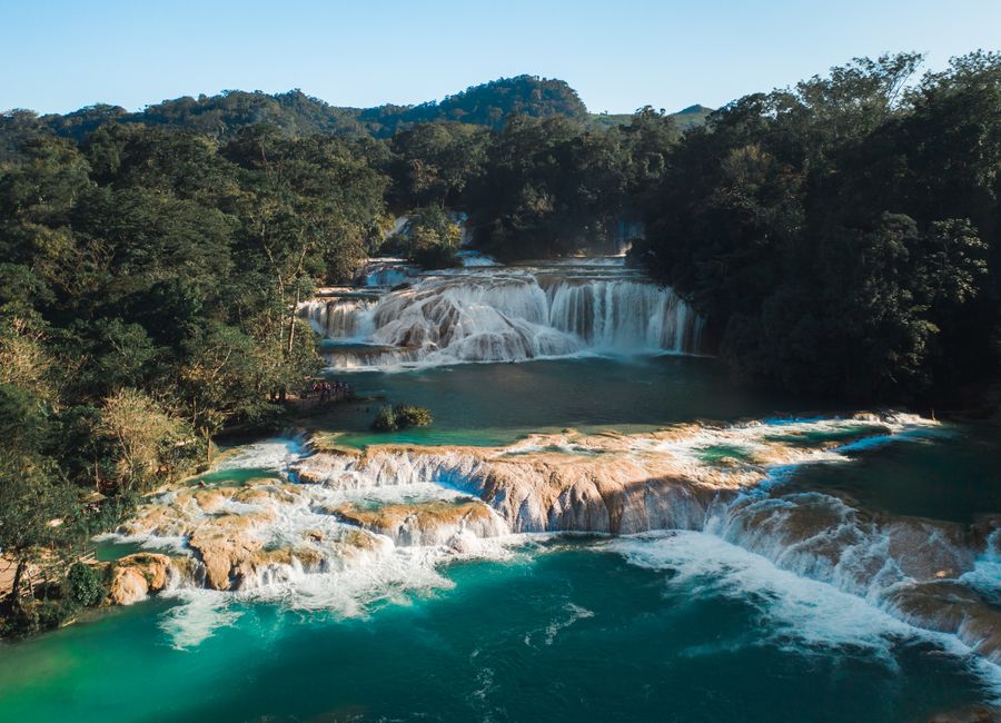 Stunning aerial shot of Agua Azul waterfalls surrounded by lush forest in Chiapas, Mexico.
