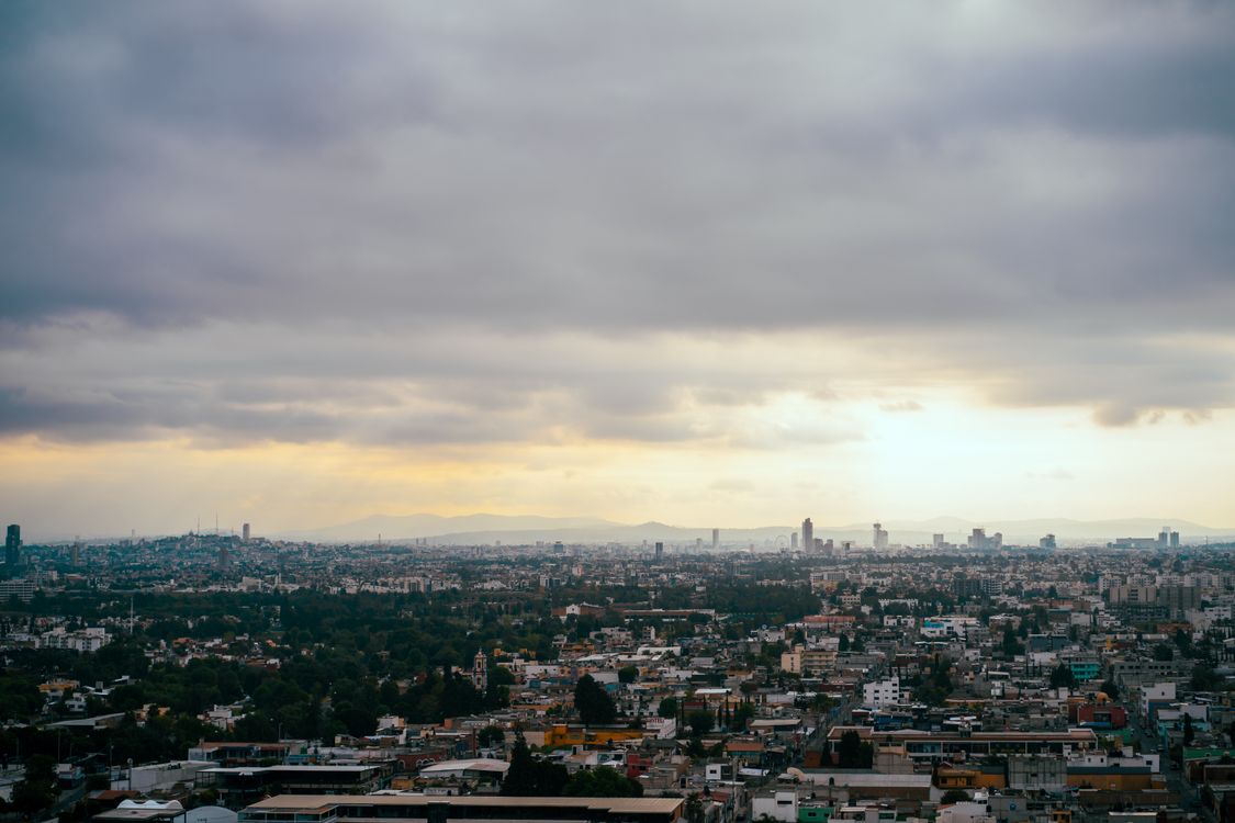 Aerial Photo of a City Under Cloudy Sky · Free Stock Photo