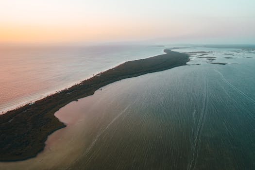 Stunning aerial shot of a Mexican coastline bathed in warm sunset hues, showcasing serene waters.