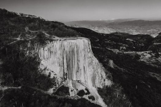 Grayscale aerial photograph of Hierve el Agua's rock formations in Oaxaca, Mexico.