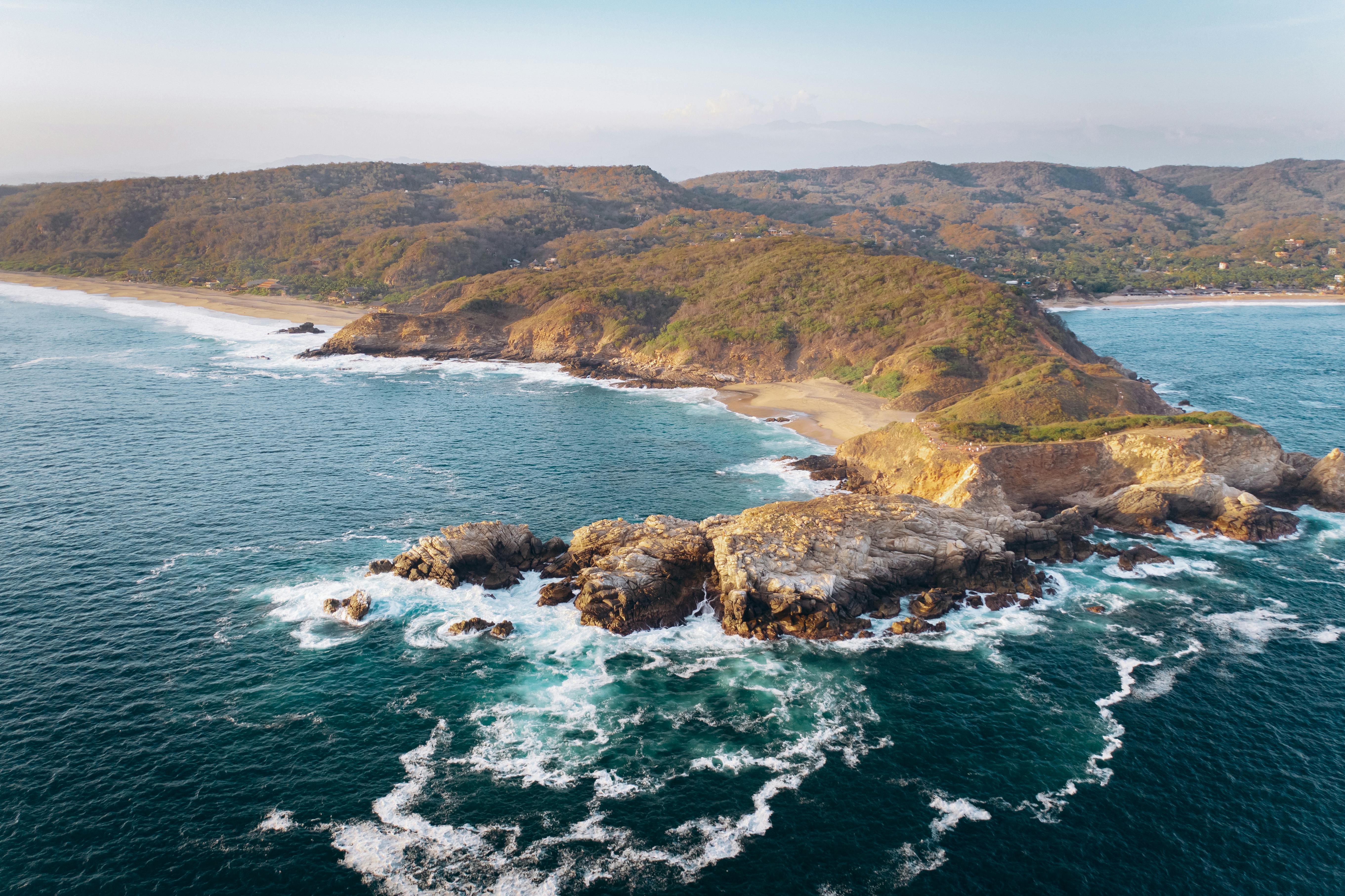 green and brown island beside blue sea