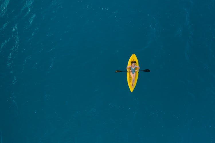 A Woman Riding A Kayak