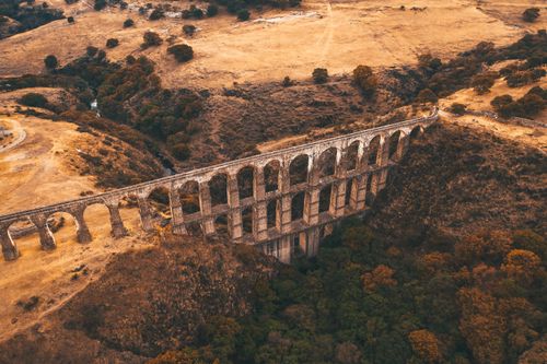 Free Aerial view of an ancient aqueduct in a picturesque Mexican landscape during autumn. Stock Photo