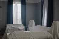 Unused Furniture Covered in White Textile