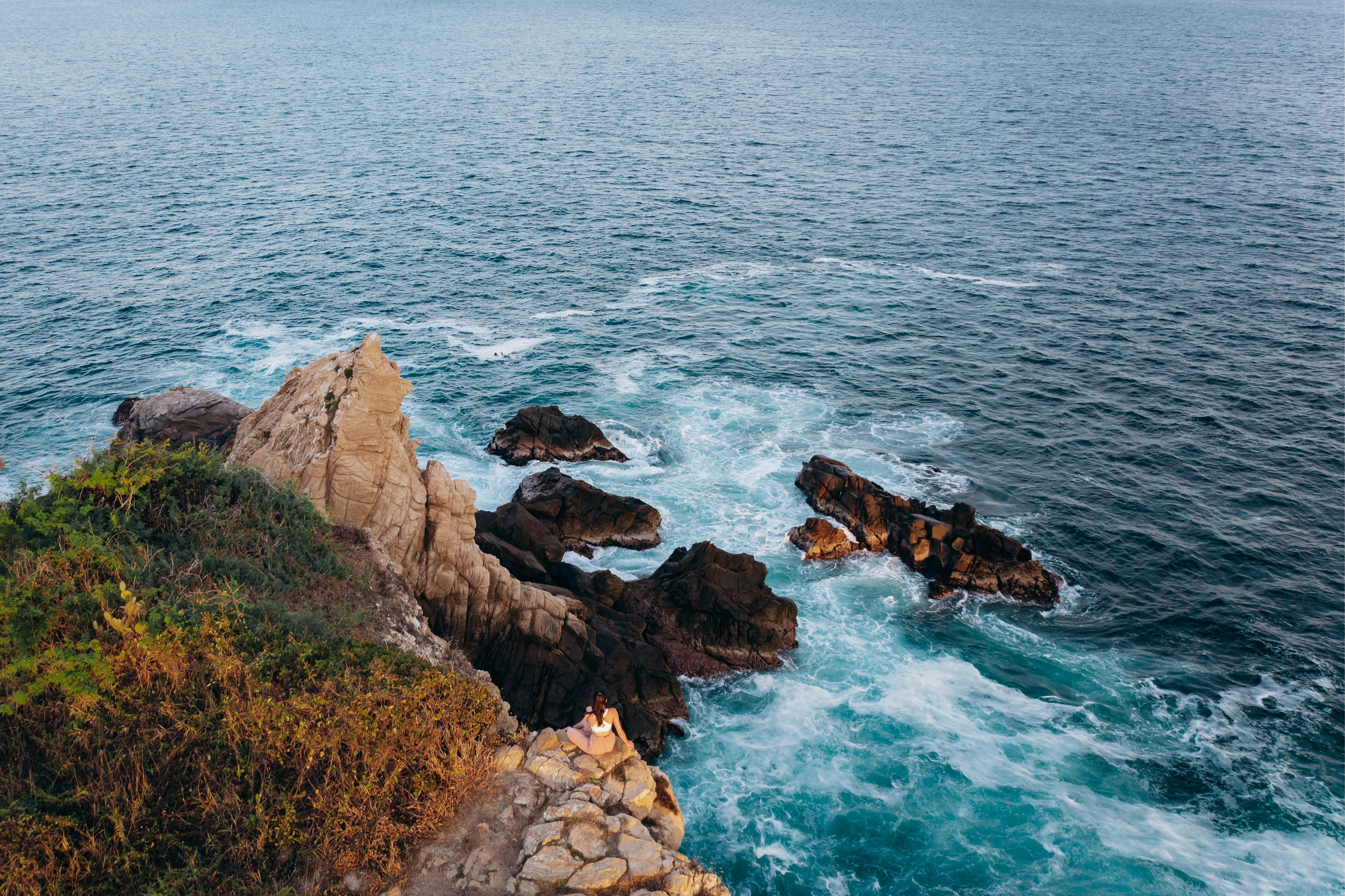 brown rocky shore with blue sea water