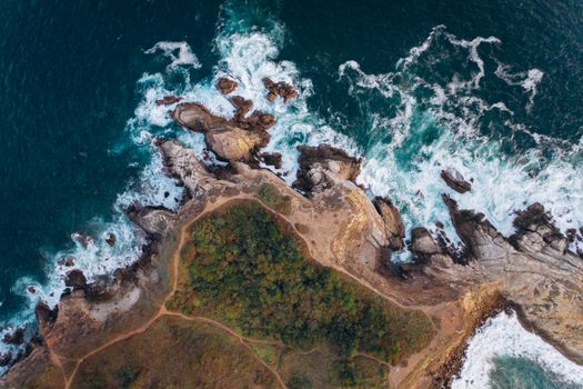 An Aerial Photography of a Rock Formations Near the Beach