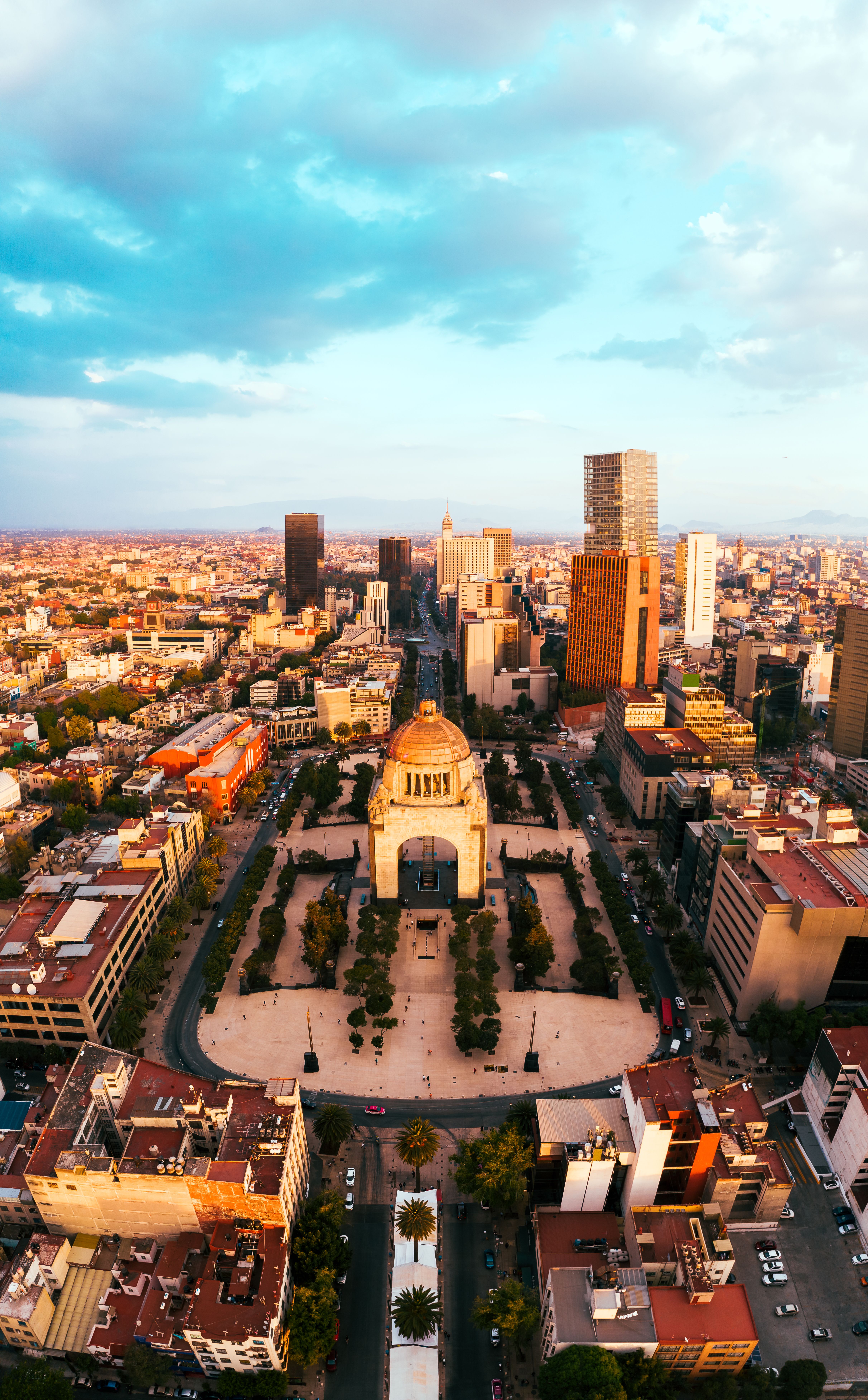 Stunning aerial shot of Mexico City's skyline with the iconic Revolution Monument in the foreground.