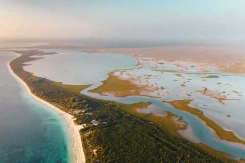 Free A breathtaking aerial panorama of a pristine coastal peninsula with lush greenery and blue waters. Stock Photo