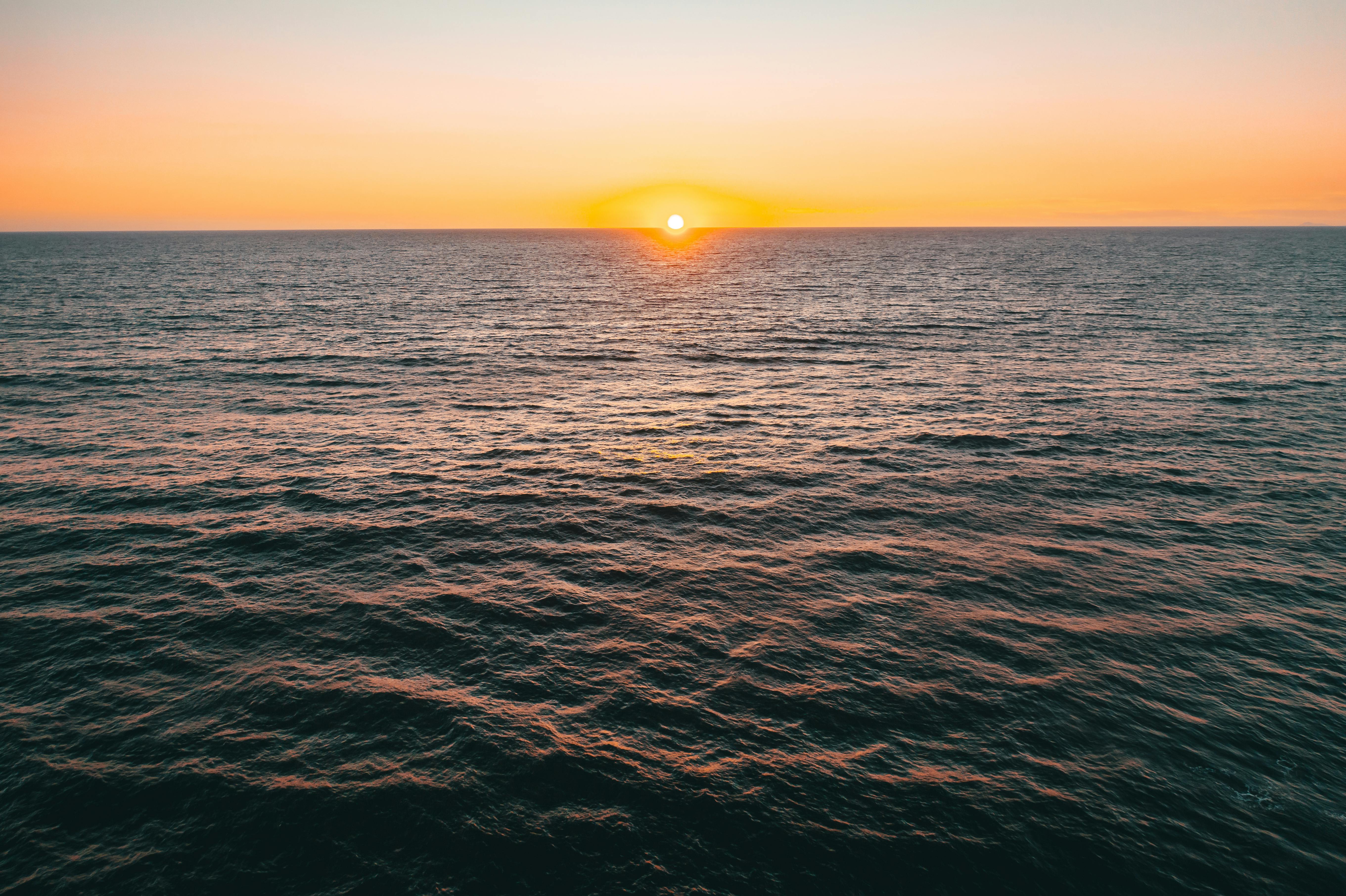 body of water during sunset