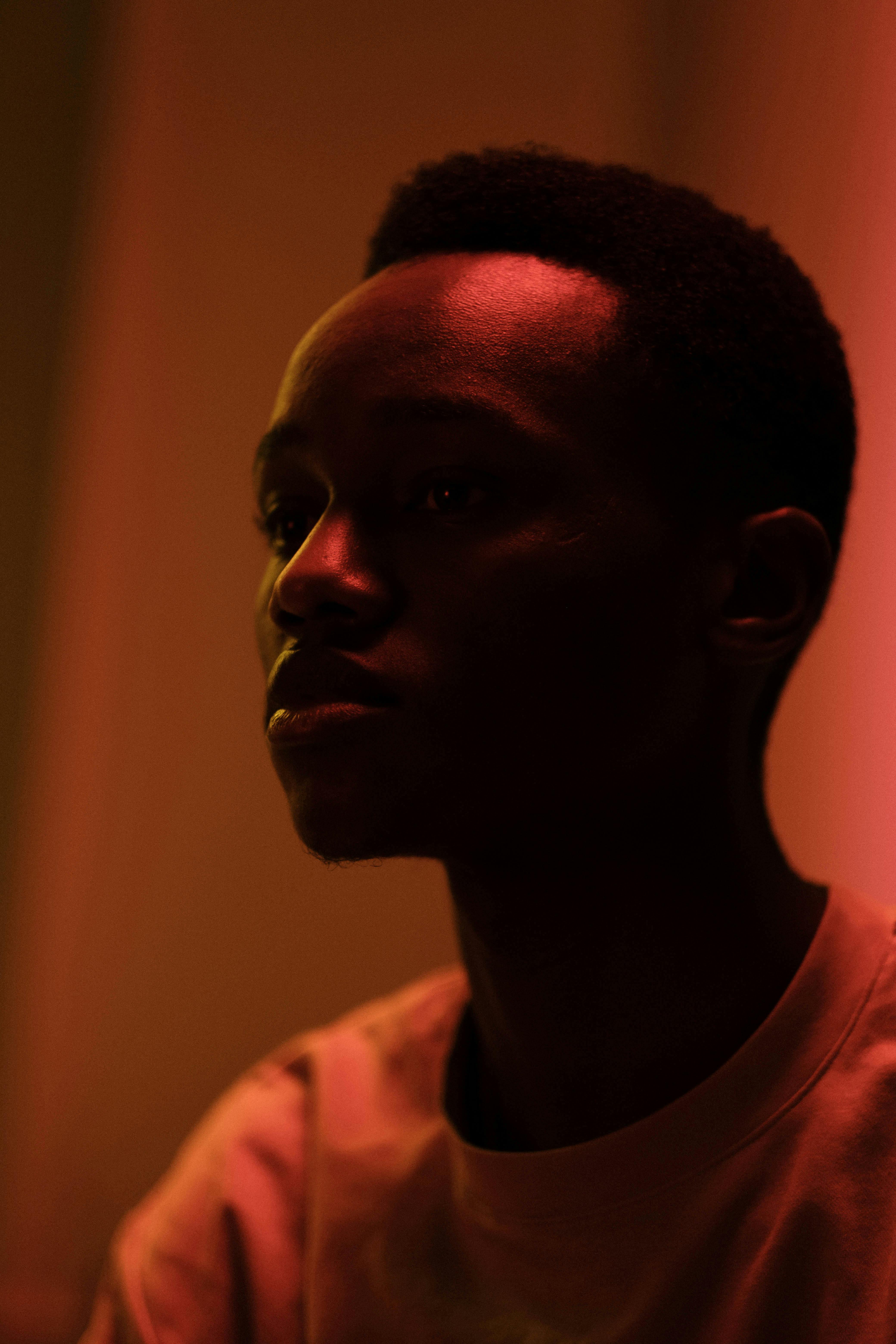 Artistic portrait of a man with moody lighting, creating a dramatic effect.