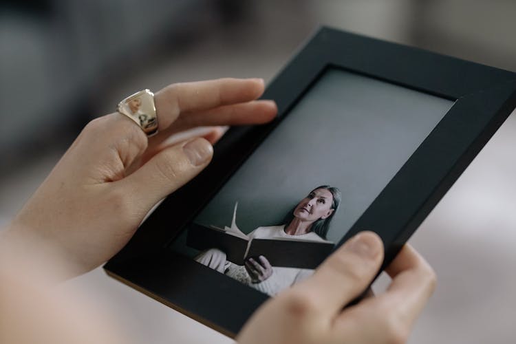 Person Holding Black Picture Frame