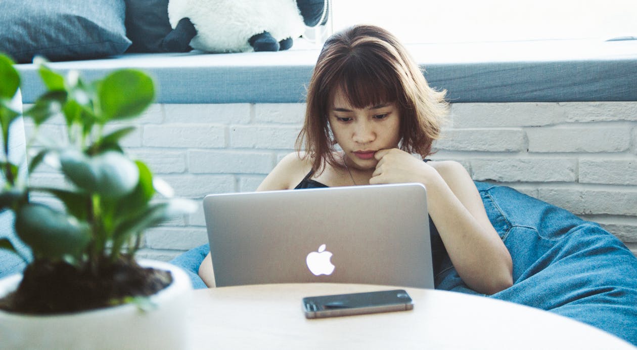 Free Woman in Black Tank Top Using Silver Macbook Stock Photo