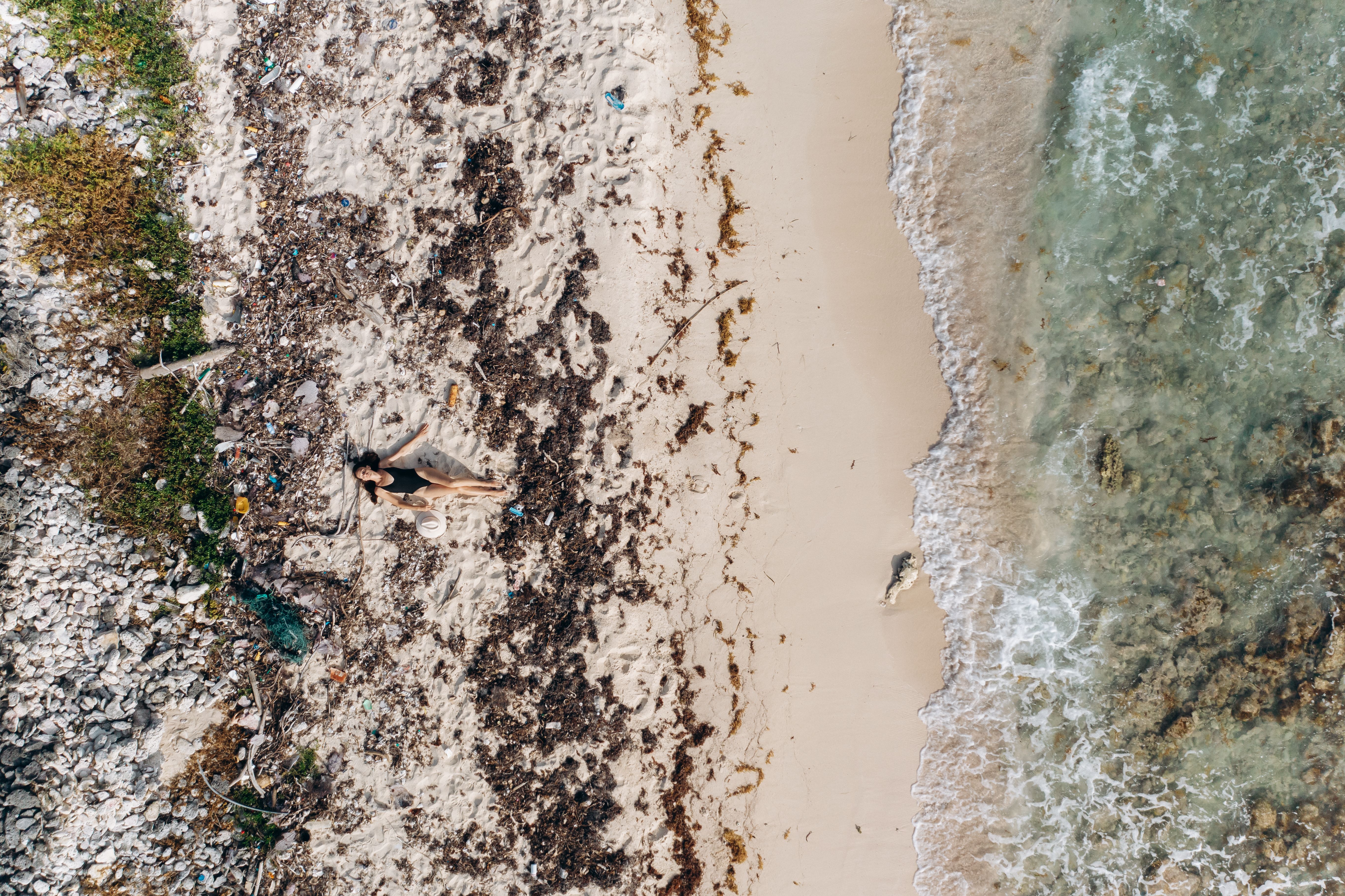Woman in Black Bikini Lying on White Sand Beach · Free Stock Photo