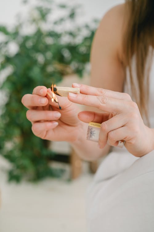 Woman in White Dress Holding Cigarette Stick