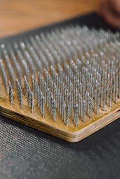 Detailed view of a wooden sadhu board with sharp metal spikes for meditation and balance.