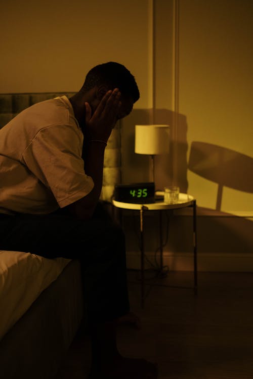 Free Man Sitting on Bed in Morning Stock Photo