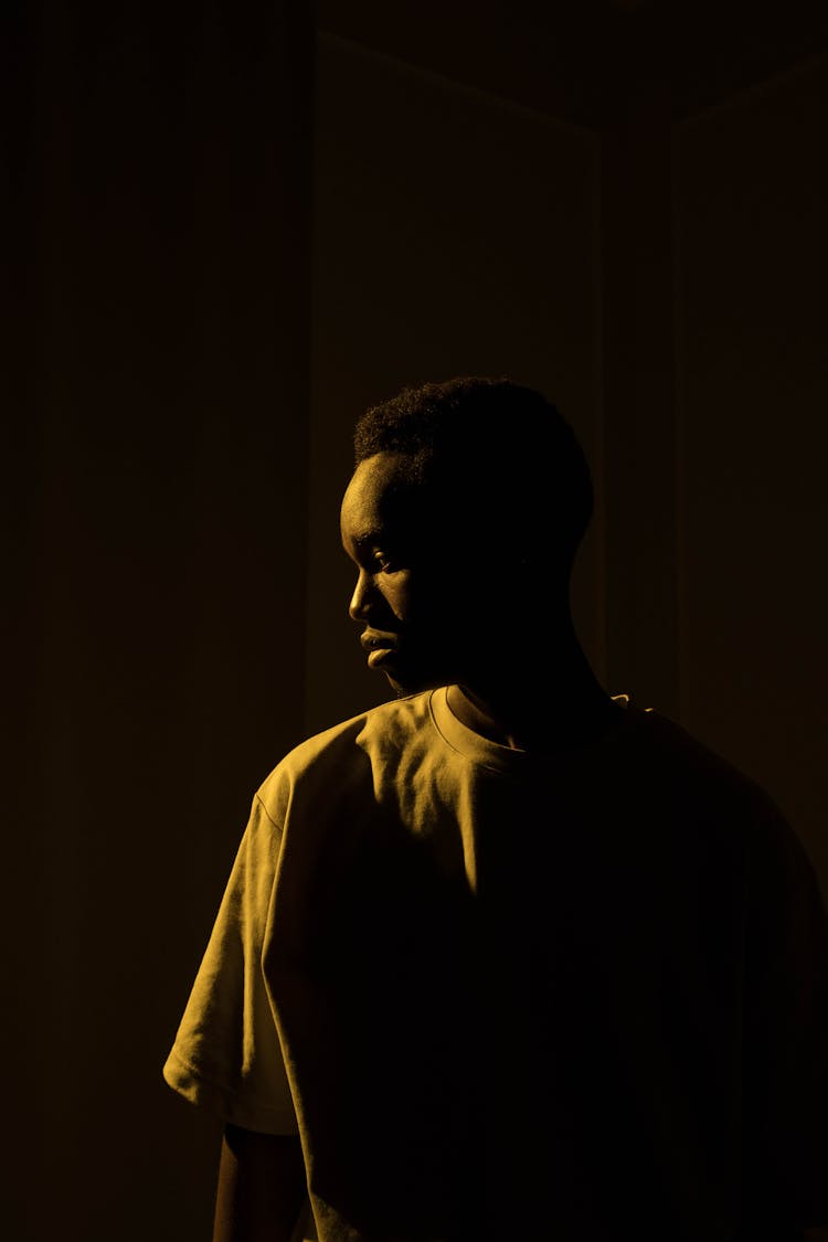 Man Standing In A Dark Interior 