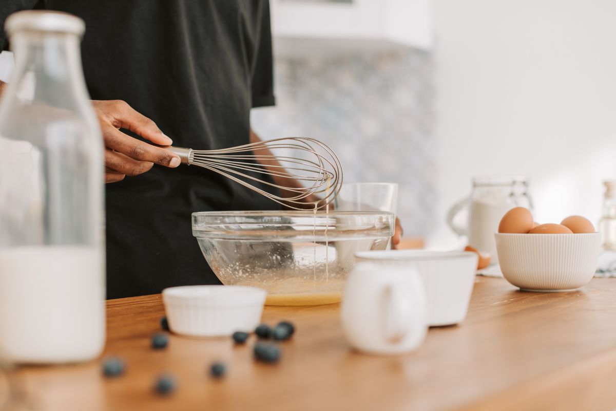 Close-up of a person whisking in a bowl on a kitchen counter — photo by Vlada Karpovich on Pexels
