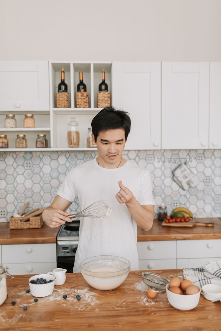 A Man Cooking In The Kitchen