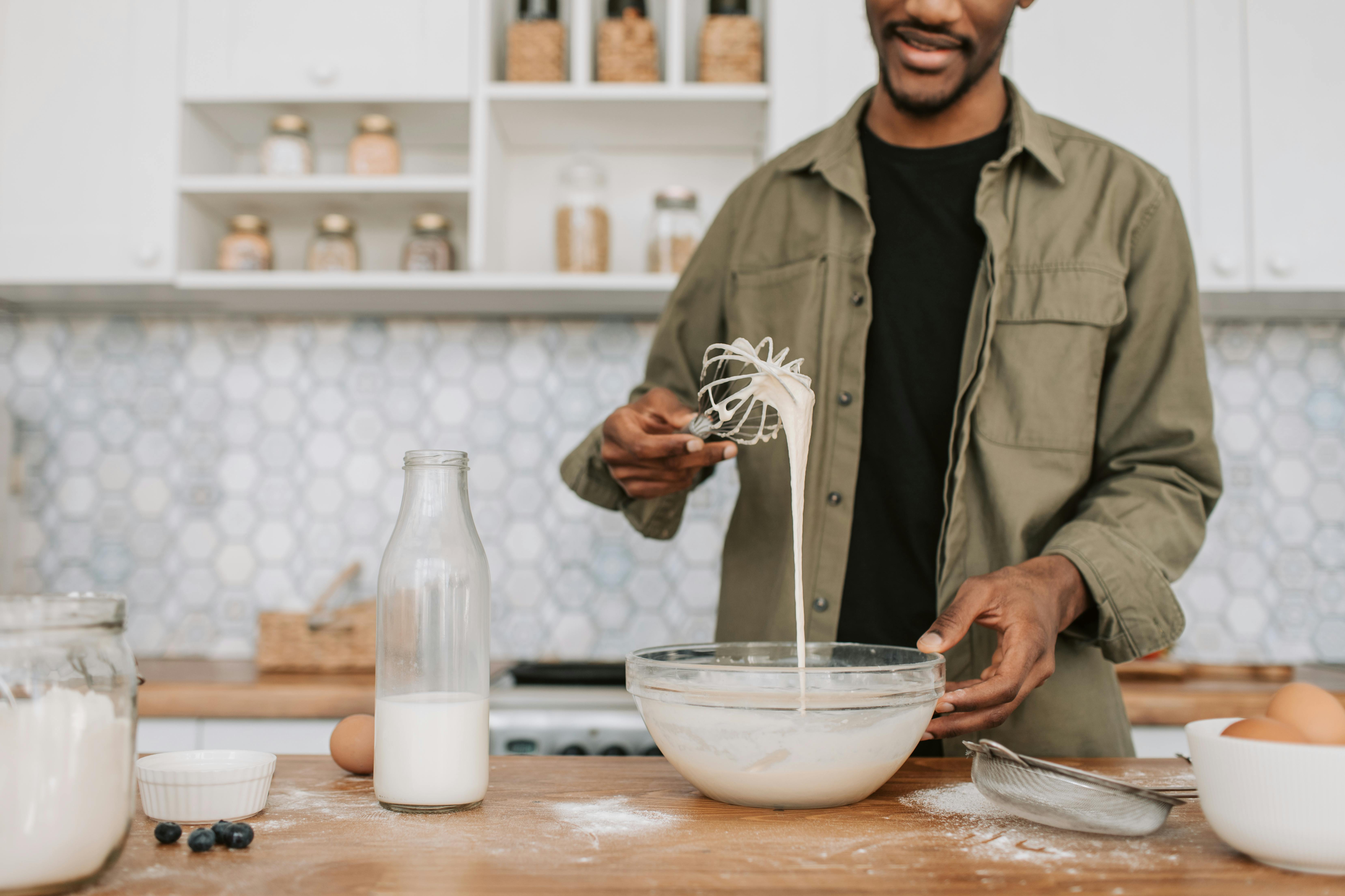 a man checking the texture of the batter