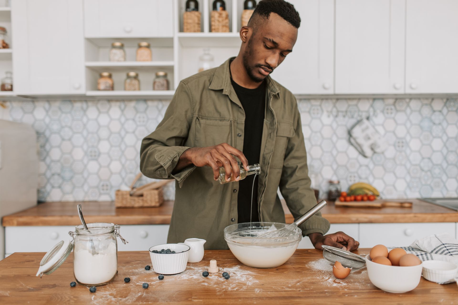 Man in Jacket Pouring Syrup on Bowl