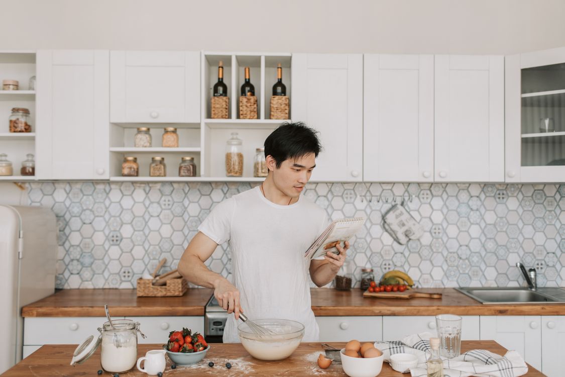 Man Using Man Cooking A Man Cooking at the Kitchen · Free Stock Photo