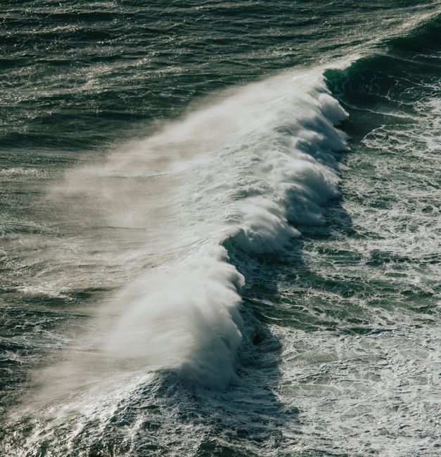 Powerful ocean waves crashing against the coast, capturing the raw beauty of nature.