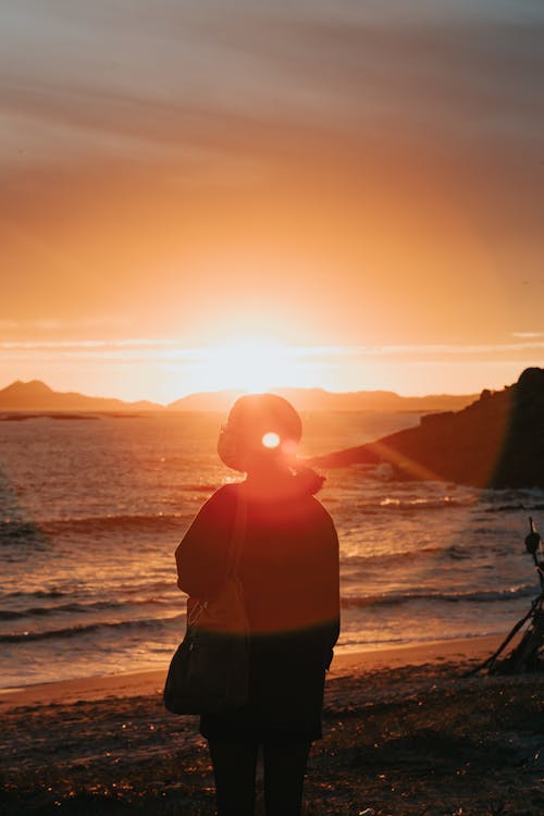 Silhouette of Woman Standing on Beach