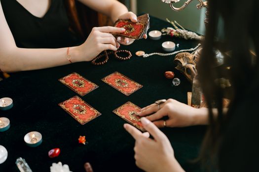 A tarot card reading session with crystals and candles, creating a mystical atmosphere.