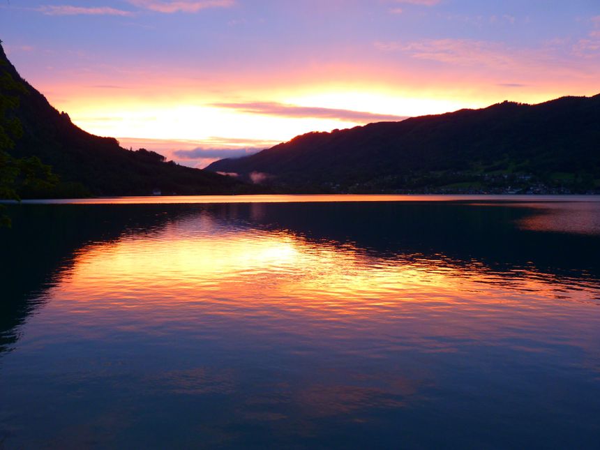 Warm sunset light over a still mountain lake — photo by Pixabay on Pexels