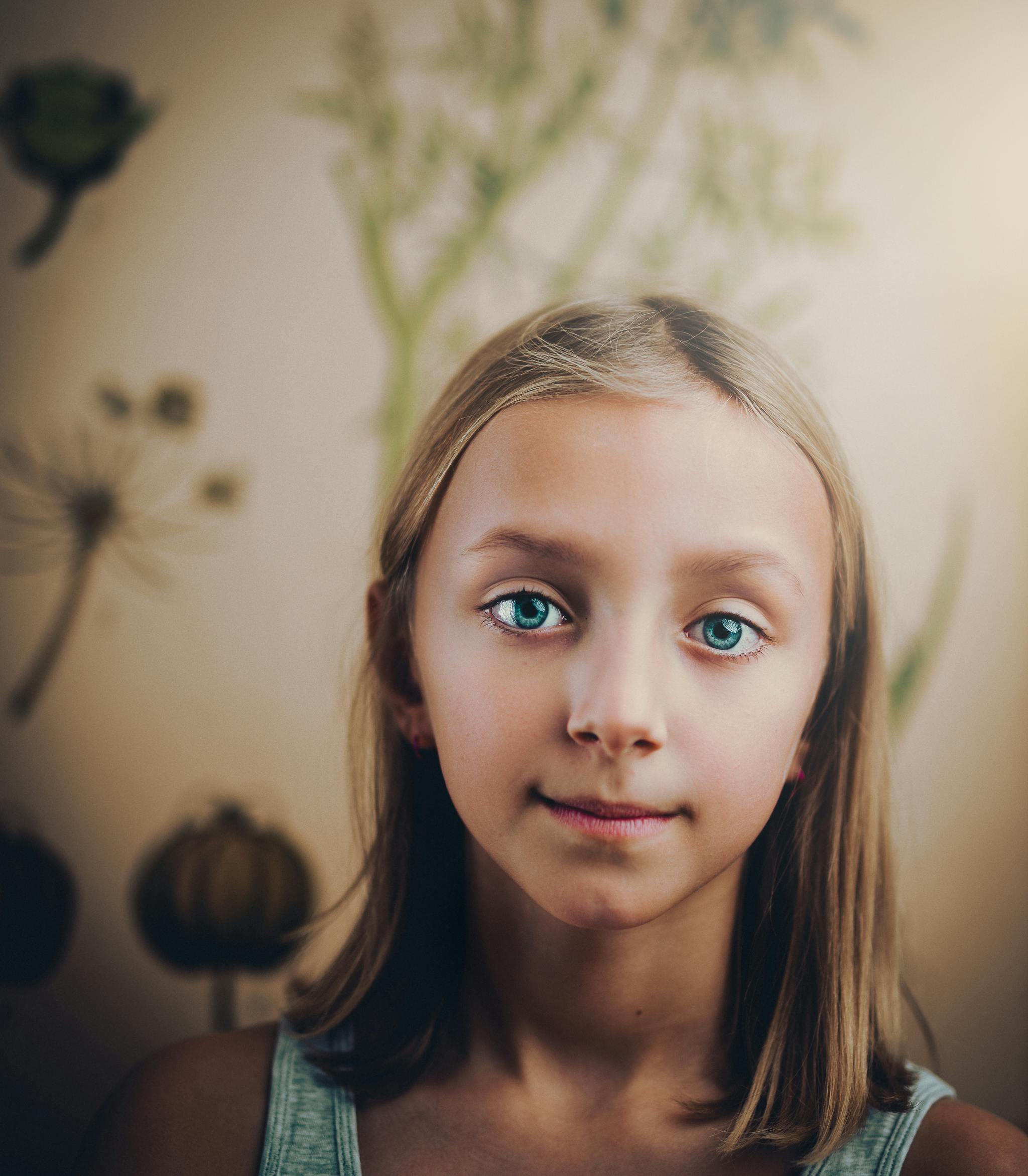 smiling girl standing in white painted wall room