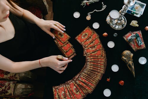 Free A Woman Spreading the Tarot Card on the Table Stock Photo