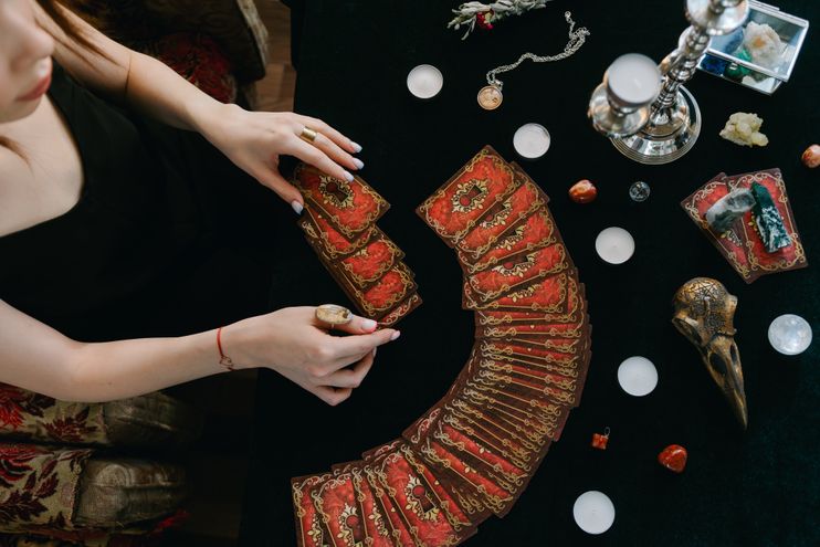 A practitioner generating and reviewing a Destiny Matrix chart on a table with candles, representing how a free calculator turns a birth date into a full reading
