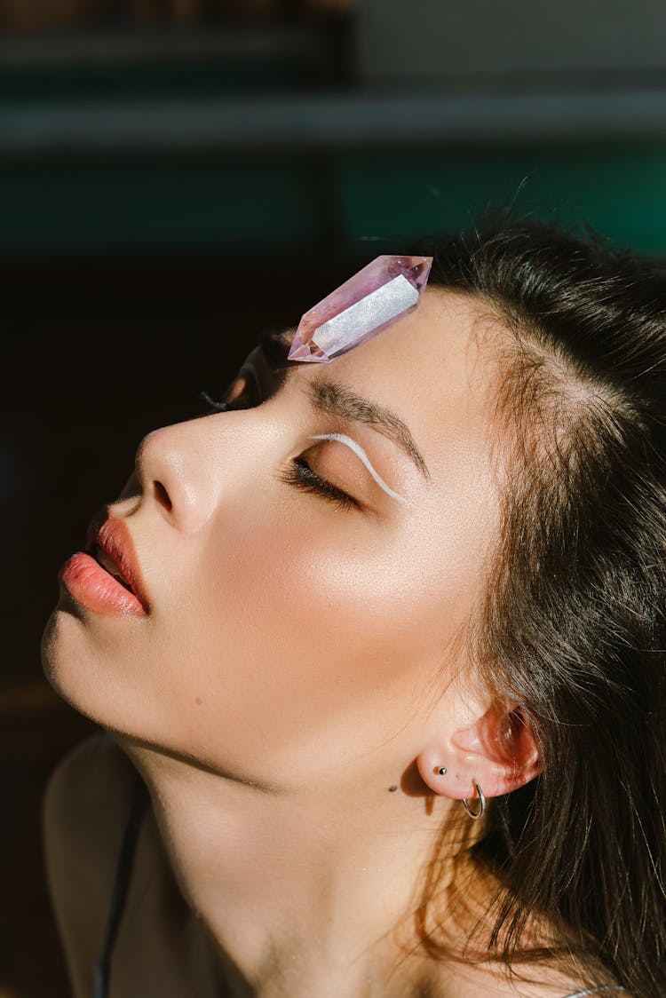 A Woman With A Crystal On Her Forehead